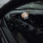 person in black jacket driving car